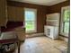 Vintage kitchen with wood paneling and white cabinets at 562 W Wilson Ave, Mooresville, NC 28115