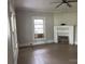 Open room with fireplace, crown molding, and natural light at 562 W Wilson Ave, Mooresville, NC 28115