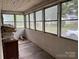 Enclosed porch has a row of windows offering outside views and lots of natural light at 562 W Wilson Ave, Mooresville, NC 28115