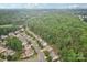 Aerial view of a neighborhood surrounded by lush greenery and mature trees at 5812 Dinsmore Ln, Belmont, NC 28012