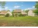 Expansive backyard with lush lawn, mature trees, and a view of the two-story home at 5812 Dinsmore Ln, Belmont, NC 28012