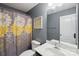 A stylish bathroom with a floral shower curtain, ample vanity space, and modern fixtures, offering a refreshing design at 5812 Dinsmore Ln, Belmont, NC 28012