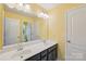 Bright bathroom featuring double sinks, sleek vanity, and ample lighting, offering both style and functionality at 5812 Dinsmore Ln, Belmont, NC 28012