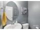 Modern half bathroom featuring sink with gray walls, and decorative artwork at 5812 Dinsmore Ln, Belmont, NC 28012