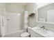 This bathroom features a shower-tub, updated vanity with a marble countertop, and stylish floating shelves at 5812 Dinsmore Ln, Belmont, NC 28012