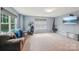 Spacious bonus room with a comfortable sofa, a window, and workout equipment at 5812 Dinsmore Ln, Belmont, NC 28012