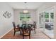 Charming dining room with stylish light fixture, window views, and slider doors to the patio at 5812 Dinsmore Ln, Belmont, NC 28012