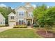 Two-story home featuring manicured landscaping, a well-maintained lawn, and inviting curb appeal at 5812 Dinsmore Ln, Belmont, NC 28012