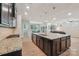 Spacious kitchen island with granite countertops and stainless steel appliances overlooking the living room at 5812 Dinsmore Ln, Belmont, NC 28012