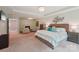 Spacious main bedroom featuring a tray ceiling, fireplace, seating area, and plush king bed at 5812 Dinsmore Ln, Belmont, NC 28012