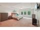 Spacious main bedroom suite with tray ceiling, plush carpet, and ample natural light creating a luxurious retreat at 5812 Dinsmore Ln, Belmont, NC 28012