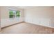 Bright, open room featuring hardwood floors, neutral paint and large window overlooking greenery at 5812 Dinsmore Ln, Belmont, NC 28012
