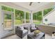 Relaxing screened porch with comfortable seating, overlooking a private backyard at 5812 Dinsmore Ln, Belmont, NC 28012