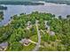 Aerial view showcases luxury homes nestled among lush trees near the tranquil lake at 5826 Natoma Rd, Lake Wylie, SC 29710