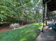 Serene backyard with lush green lawn and mature trees, providing a private oasis at 5826 Natoma Rd, Lake Wylie, SC 29710
