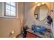 Stylish powder room featuring a blue glass bowl sink, vessel faucet, and a round mirror at 5826 Natoma Rd, Lake Wylie, SC 29710