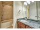 Bathroom featuring granite countertop, tiled shower, neutral walls, and framed mirror at 5826 Natoma Rd, Lake Wylie, SC 29710