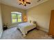 Cozy bedroom featuring neutral walls, a comfortable bed, and a large window for natural light at 5826 Natoma Rd, Lake Wylie, SC 29710