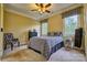 Bright bedroom with natural light, patterned bedding, and dark wood furniture at 5826 Natoma Rd, Lake Wylie, SC 29710