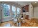 Bright dining area featuring backyard views, hardwood floors, classic furniture, and a wine cabinet at 5826 Natoma Rd, Lake Wylie, SC 29710