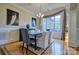Chic dining room with modern lighting, neutral tones, hardwood floors, and large window with drapes at 5826 Natoma Rd, Lake Wylie, SC 29710