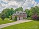 Beautiful two-story brick home with lush landscaping and a spacious driveway at 5826 Natoma Rd, Lake Wylie, SC 29710