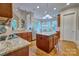 Open kitchen featuring granite countertops, a central island, hardwood floors, stainless appliances, and backyard views at 5826 Natoma Rd, Lake Wylie, SC 29710