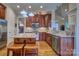 Bright kitchen features wooden cabinets, granite countertops, stainless appliances, and a spacious center island at 5826 Natoma Rd, Lake Wylie, SC 29710
