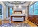 Bright main bedroom with hardwood floors, a large bed, and abundant natural light from the windows at 5826 Natoma Rd, Lake Wylie, SC 29710