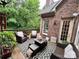 Inviting outdoor patio with comfortable seating and views of the surrounding trees and landscape at 5826 Natoma Rd, Lake Wylie, SC 29710