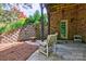 An outdoor patio features a brick wall and comfortable chairs for relaxation at 5826 Natoma Rd, Lake Wylie, SC 29710