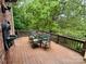 Outdoor patio featuring dining table with backyard views and a water fountain feature on the brick wall at 5826 Natoma Rd, Lake Wylie, SC 29710