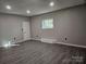 Finished basement offers natural light, wood floors, and painted walls, creating a bright, adaptable space at 7154 Woodcock Trl, Stanley, NC 28164