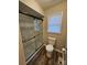 Modern bathroom with a sleek glass-enclosed shower and updated toilet at 7154 Woodcock Trl, Stanley, NC 28164