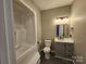 Bathroom featuring a vanity with storage and a tub-shower combo with neutral finishes at 7154 Woodcock Trl, Stanley, NC 28164
