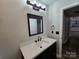 Bathroom with updated vanity, fixtures, mirror and lighting at 7154 Woodcock Trl, Stanley, NC 28164