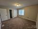 Cozy bedroom with a window and a spacious closet, perfect for relaxation at 7154 Woodcock Trl, Stanley, NC 28164