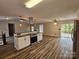 Open-concept kitchen with modern appliances, a central island, and plenty of countertop space perfect for cooking at 7154 Woodcock Trl, Stanley, NC 28164