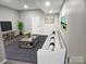 Comfortable living area with a modern sofa, stylish coffee table, and a large TV for cozy relaxation at 7154 Woodcock Trl, Stanley, NC 28164