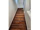 Stairs leading to the upper level, featuring dark wood treads at 7154 Woodcock Trl, Stanley, NC 28164