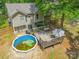 Aerial view of backyard featuring pool, deck, trees, and house at 7206 Stoney Place Ct, Charlotte, NC 28262