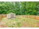 This backyard has a storage shed and a long fence at 7206 Stoney Place Ct, Charlotte, NC 28262