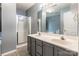 Bathroom featuring a double sink vanity, a large mirror, and a glass-enclosed shower at 7206 Stoney Place Ct, Charlotte, NC 28262