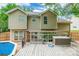 View of back of house from backyard deck, showing pool and hot tub at 7206 Stoney Place Ct, Charlotte, NC 28262