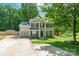 Charming two-story home featuring a well-manicured lawn, a driveway, and lush trees in a desirable neighborhood at 7206 Stoney Place Ct, Charlotte, NC 28262