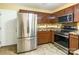 Well-equipped kitchen with stainless steel appliances, tile backsplash, and warm-toned wooden cabinetry at 7206 Stoney Place Ct, Charlotte, NC 28262