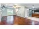 Spacious living room featuring hardwood floors, neutral walls, open floor plan, and access to the kitchen at 7206 Stoney Place Ct, Charlotte, NC 28262