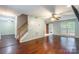 Open concept living room with hardwood floors, staircase, neutral walls, and sliding glass doors to the backyard at 7206 Stoney Place Ct, Charlotte, NC 28262