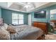 Spacious main bedroom with a tray ceiling, ceiling fan, dresser and television at 7206 Stoney Place Ct, Charlotte, NC 28262