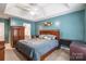 Main bedroom showcasing a king-size bed, elegant furniture, and access to the ensuite bathroom at 7206 Stoney Place Ct, Charlotte, NC 28262